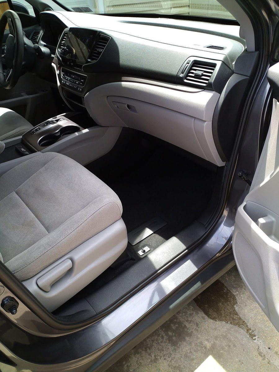 Detailed vehicle interior with freshly cleaned seats, console, and dashboard