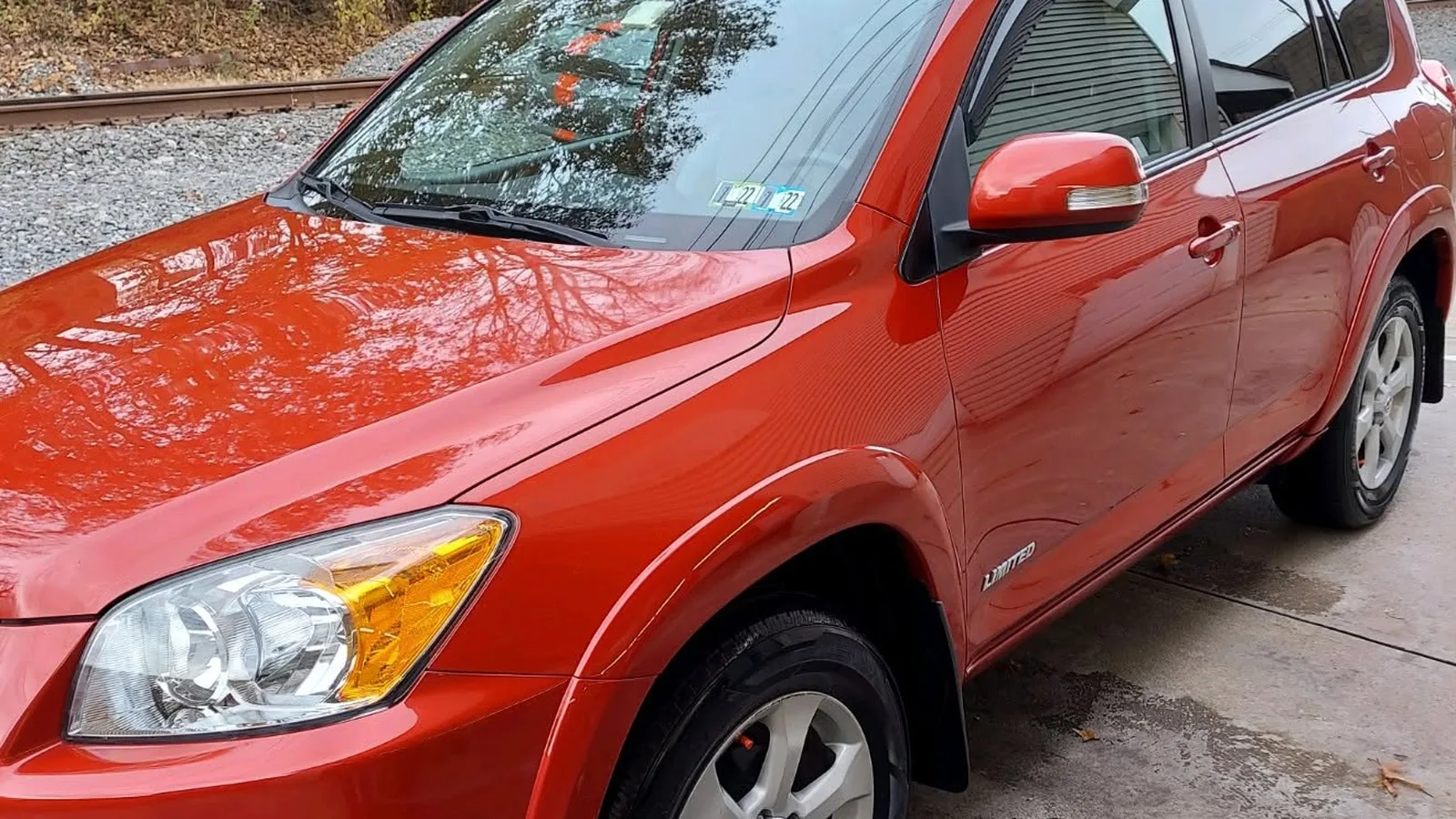 Red SUV after professional exterior detailing with a glossy protected finish
